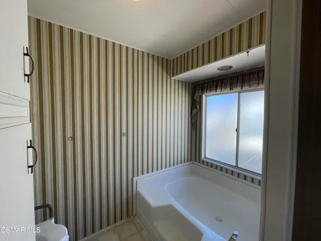 a bathroom with a tub and a sink