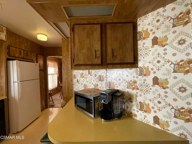 a kitchen with a sink and refrigerator