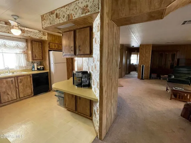 a kitchen with stainless steel appliances a stove a refrigerator and a sink