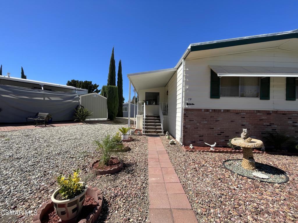 6480 Katherine Road, Unit 79 Simi Valley, CA 93063 - Photo 2 of 40 a front view of a house with a yard