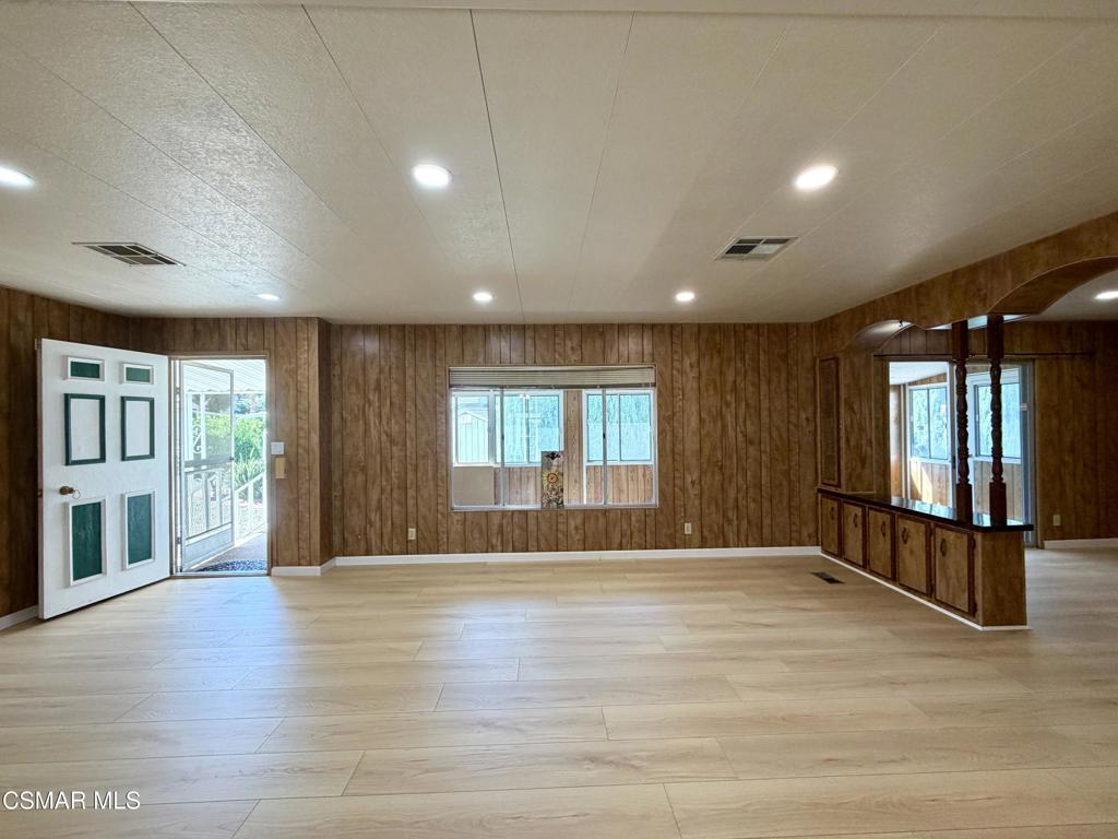 6480 Katherine Road, Unit 79 Simi Valley, CA 93063 - Photo 30 of 40 a view of an empty room with wooden floor and a window