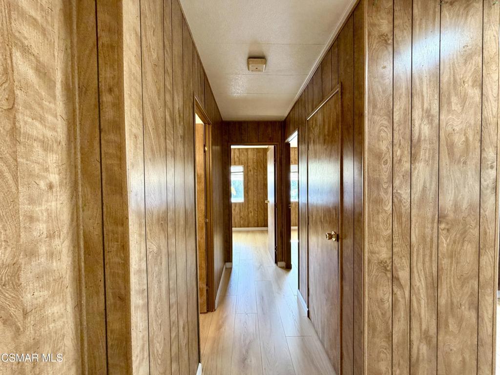 6480 Katherine Road, Unit 79 Simi Valley, CA 93063 - Photo 31 of 40 a view of a hallway with wooden floor
