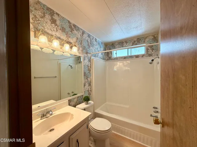 a bathroom with a toilet a sink and shower