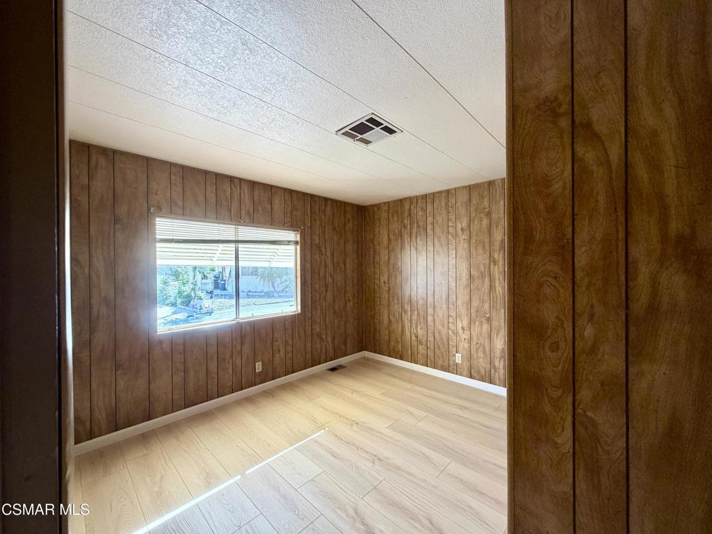 6480 Katherine Road, Unit 79 Simi Valley, CA 93063 - Photo 36 of 40 a view of an empty room with wooden floor and a window