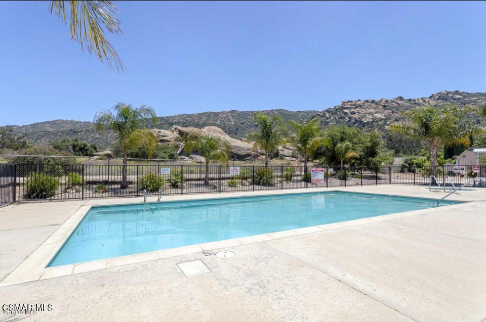 6480 Katherine Road, Unit 79 Simi Valley, CA 93063 - Photo 38 of 40 a view of a swimming pool and trees in the background
