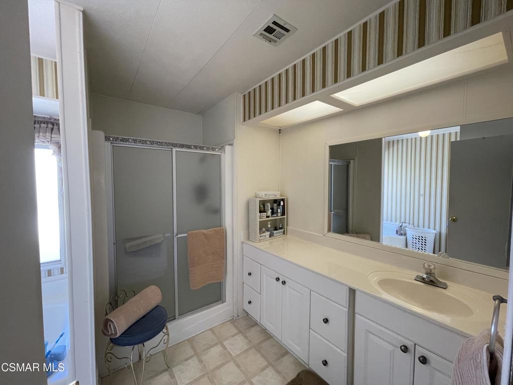 6480 Katherine Road, Unit 79 Simi Valley, CA 93063 - Photo 10 of 40 a bathroom with a double vanity sink and mirror