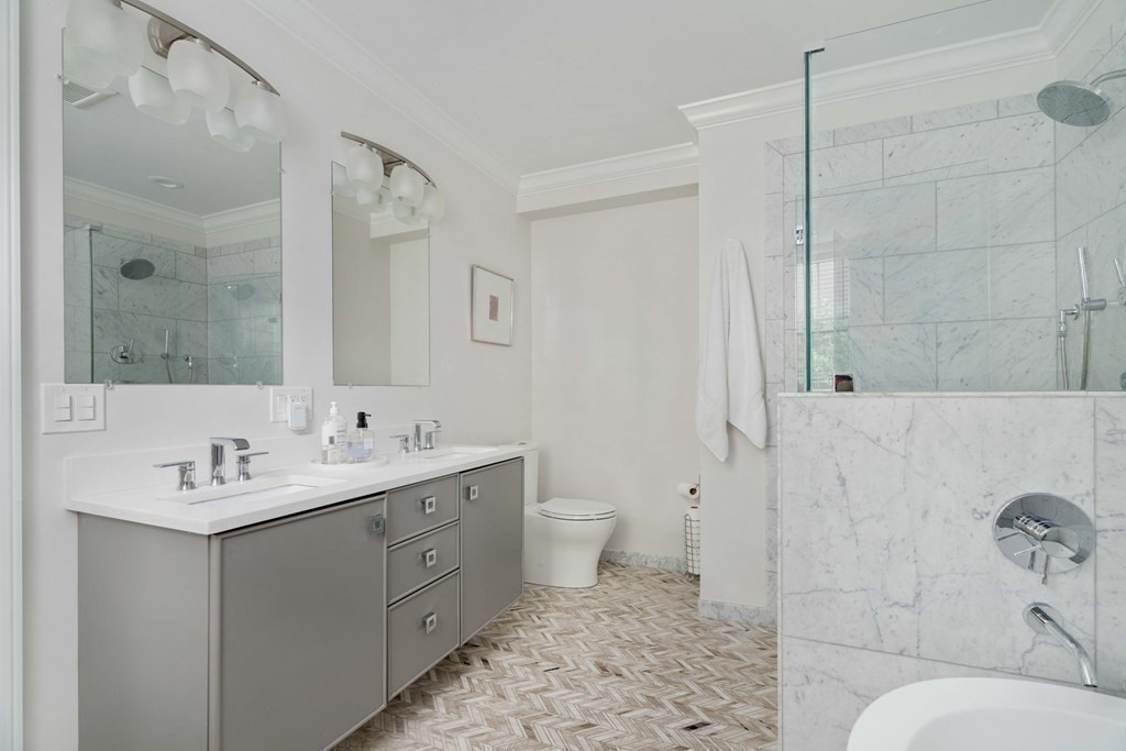 55 Addington Road, Unit 1 Brookline, MA 02445 - Photo 15 of 33 a spacious bathroom with a double vanity sink toilet and shower