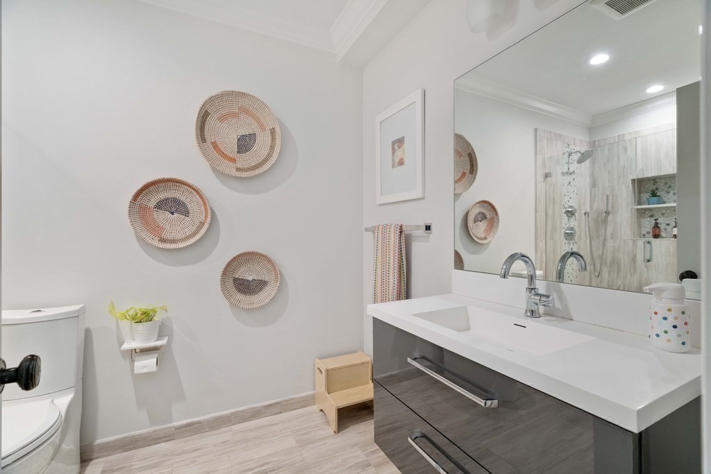 55 Addington Road, Unit 1 Brookline, MA 02445 - Photo 20 of 33 a bathroom with a sink and a mirror