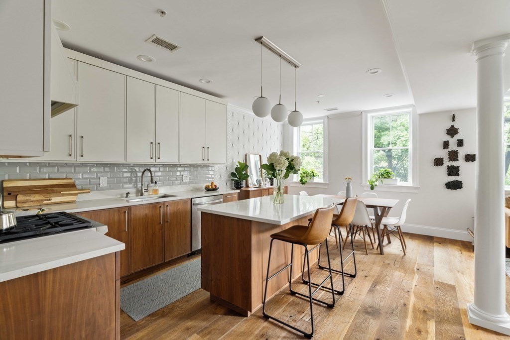 55 Addington Road, Unit 1 Brookline, MA 02445 - Photo 2 of 33 a kitchen with a table chairs stove and cabinets