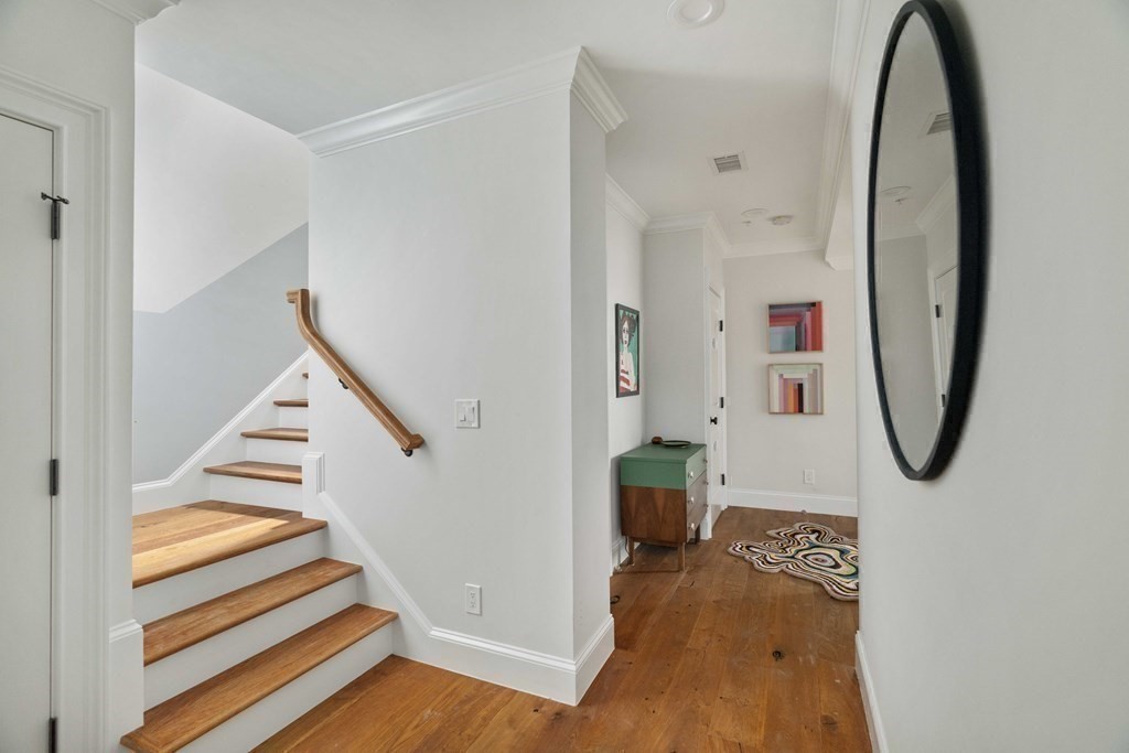 55 Addington Road, Unit 1 Brookline, MA 02445 - Photo 25 of 33 a view of a hallway with wooden floor and entryway