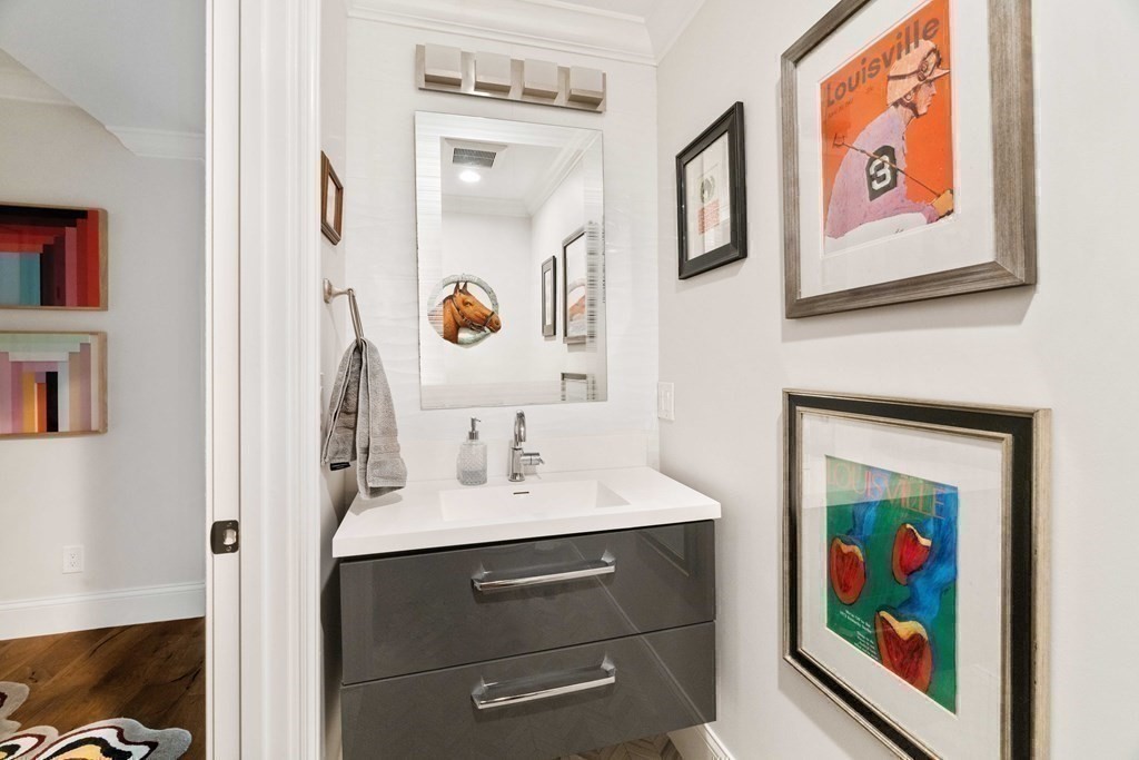 55 Addington Road, Unit 1 Brookline, MA 02445 - Photo 27 of 33 a bathroom with a sink a vanity and a painting on the wall