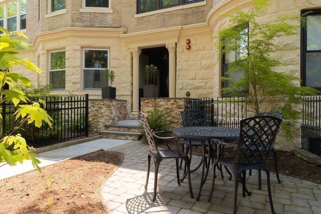 55 Addington Road, Unit 1 Brookline, MA 02445 - Photo 29 of 33 a view of a patio with table and chairs and potted plants
