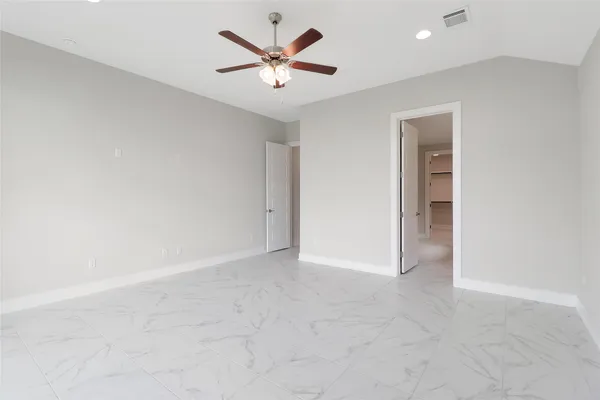 a bathroom with a tub shower sink and mirror