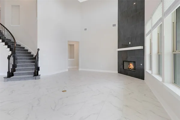 a view of an empty room with a fireplace