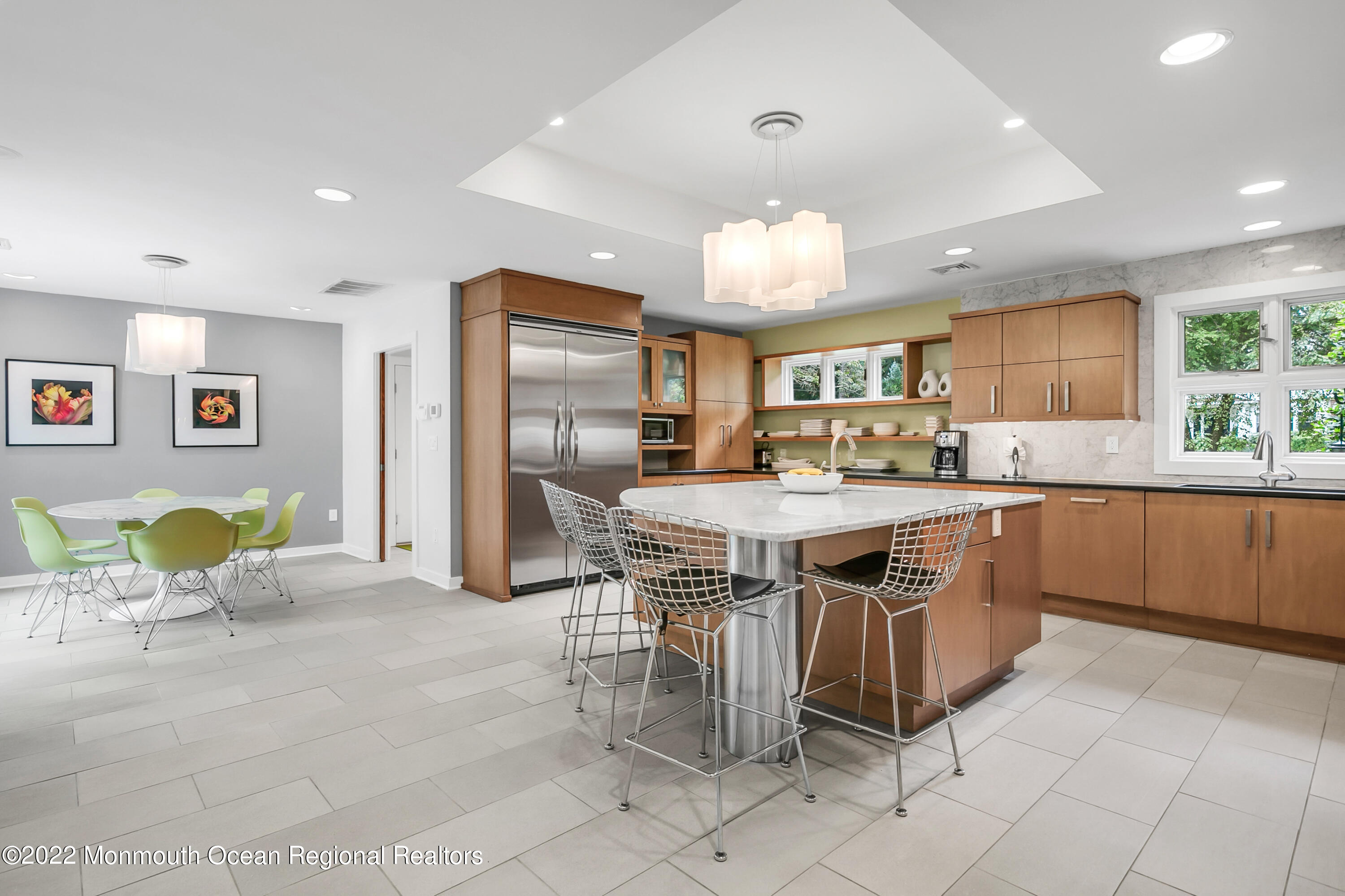 a kitchen with stainless steel appliances kitchen island granite countertop a sink and cabinets