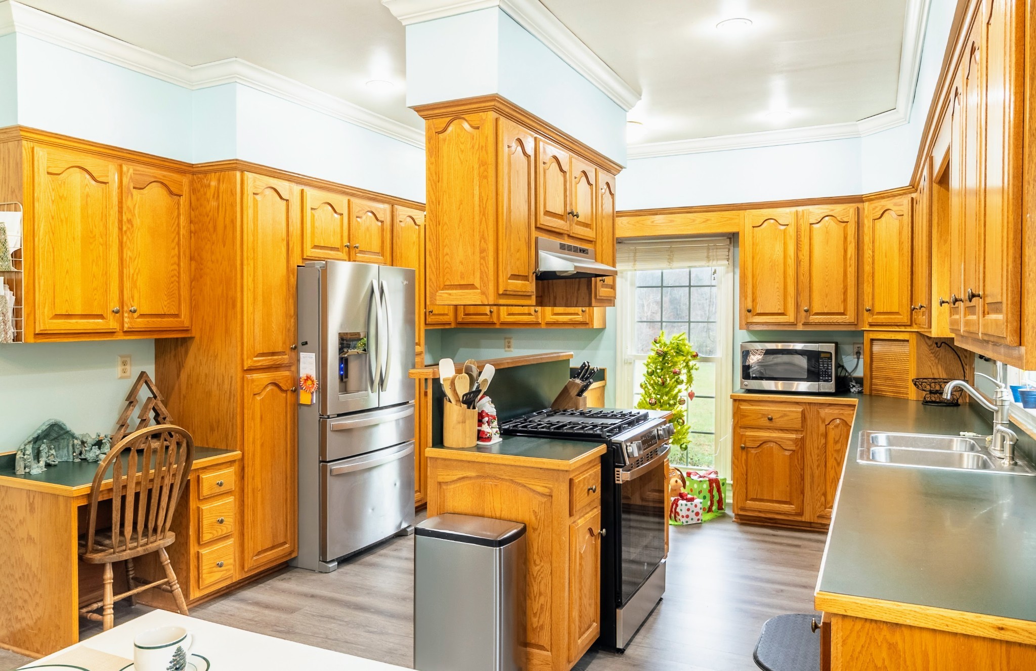 1910 Cedar Creek Road Vanleer, TN 37181 - Photo 12 of 44 a kitchen with stainless steel appliances a stove a refrigerator a sink a stove and cabinets
