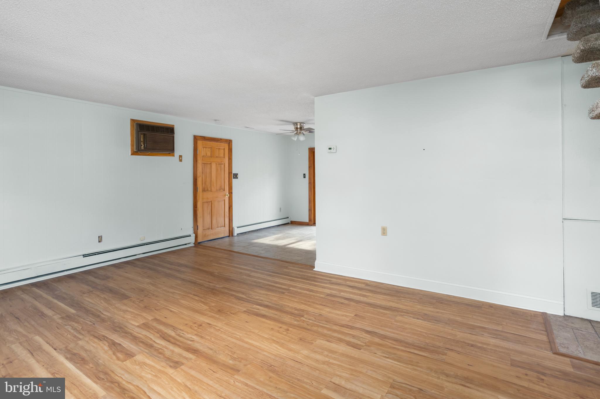 23 Cotton Road Levittown, PA 19057 - Photo 7 of 36 a view of an empty room and wooden floor