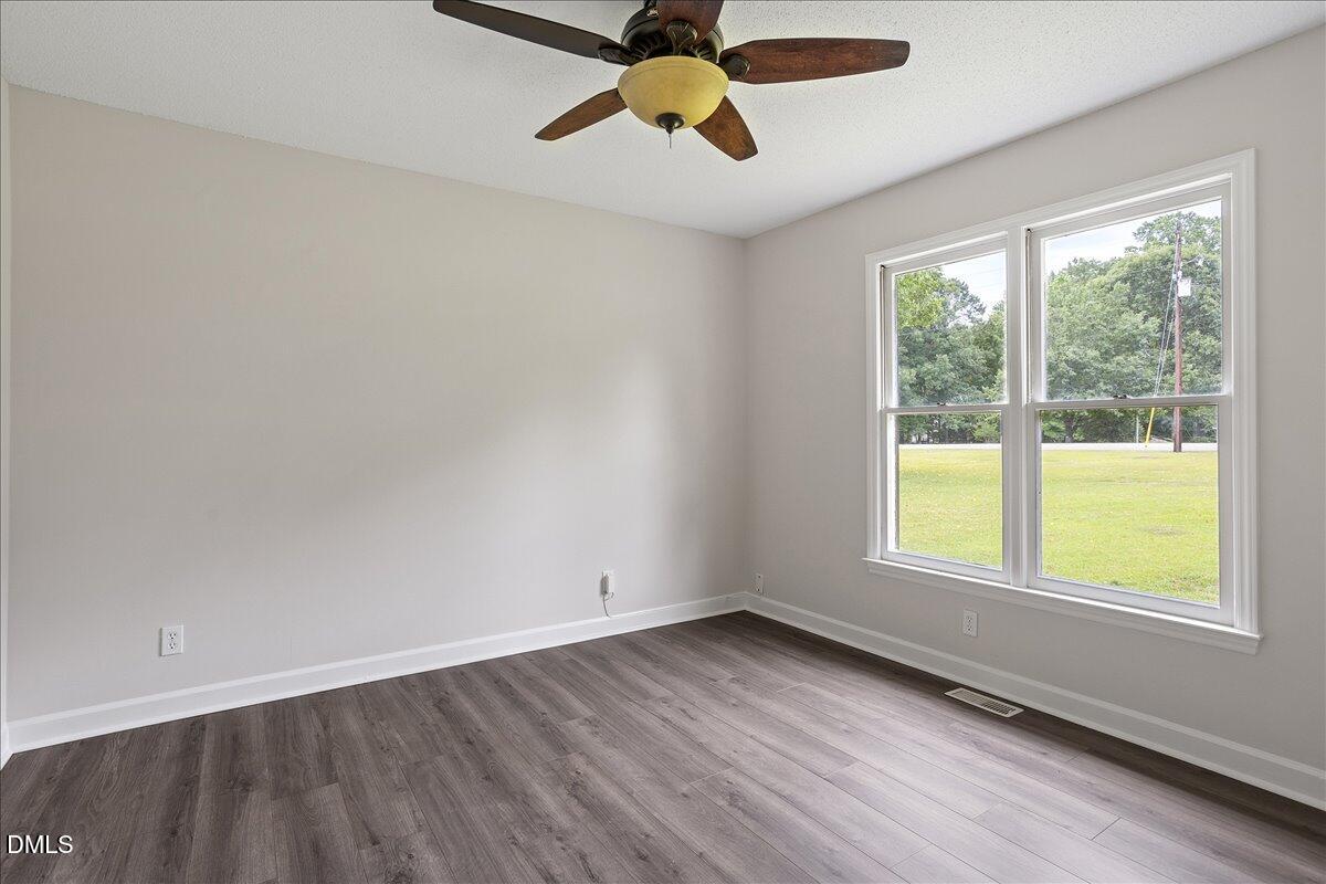 805 Rand Road Garner, NC 27529 - Photo 34 of 38 wooden floor in an empty room with a window
