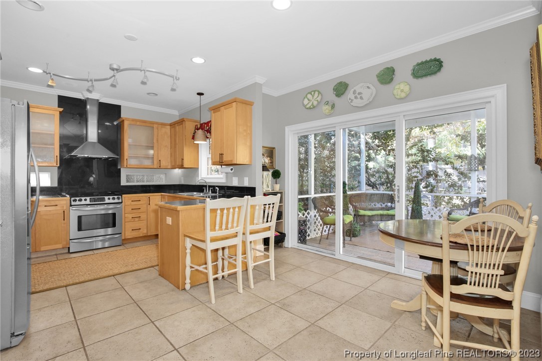 1145 Burning Tree Road Pinehurst, NC 28374 - Photo 11 of 45 a kitchen with granite countertop a stove a sink and a microwave