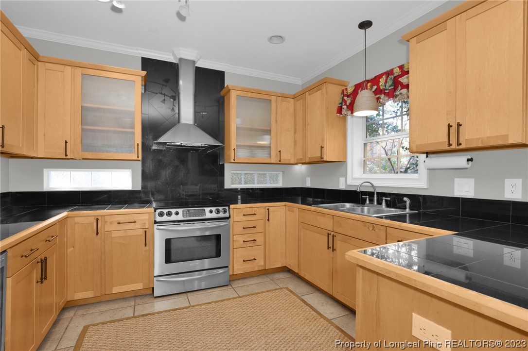 1145 Burning Tree Road Pinehurst, NC 28374 - Photo 13 of 45 a kitchen with stainless steel appliances granite countertop a stove a sink and a microwave