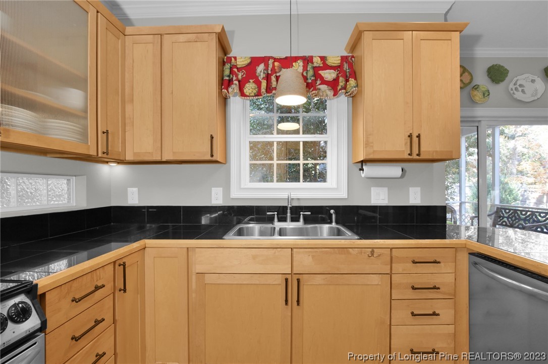 1145 Burning Tree Road Pinehurst, NC 28374 - Photo 15 of 45 a kitchen with granite countertop a sink and a stove top oven