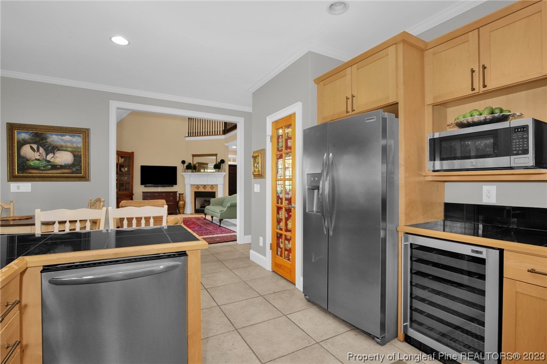 1145 Burning Tree Road Pinehurst, NC 28374 - Photo 16 of 45 a kitchen with stainless steel appliances a refrigerator stove and sink