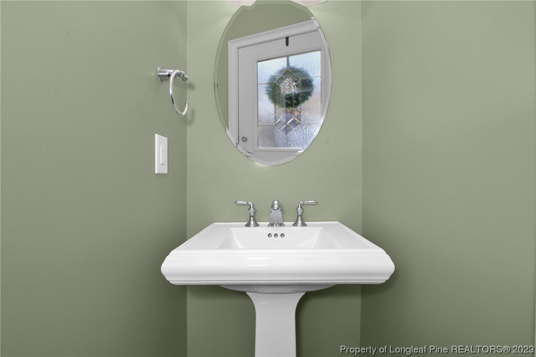 1145 Burning Tree Road Pinehurst, NC 28374 - Photo 17 of 45 a bathroom with a sink and a mirror