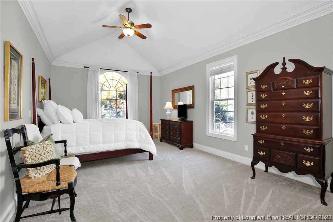 1145 Burning Tree Road Pinehurst, NC 28374 - Photo 19 of 45 a bedroom with a bed a chair and potted plant on the dresser