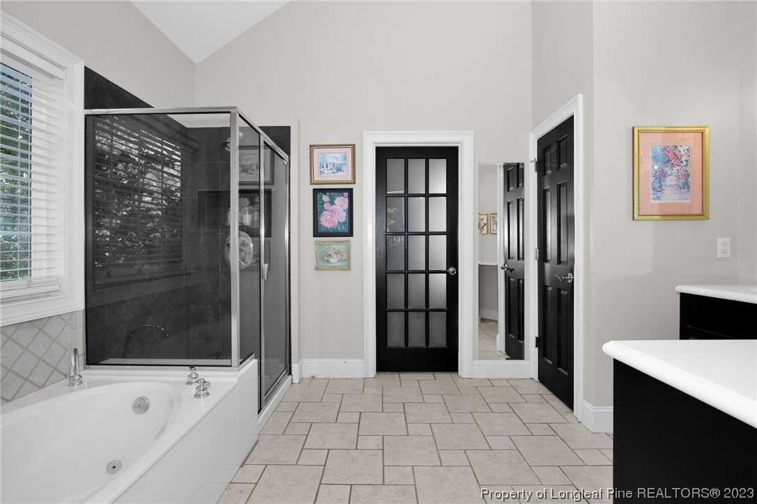 1145 Burning Tree Road Pinehurst, NC 28374 - Photo 21 of 45 a bathroom with a bathtub and a shower