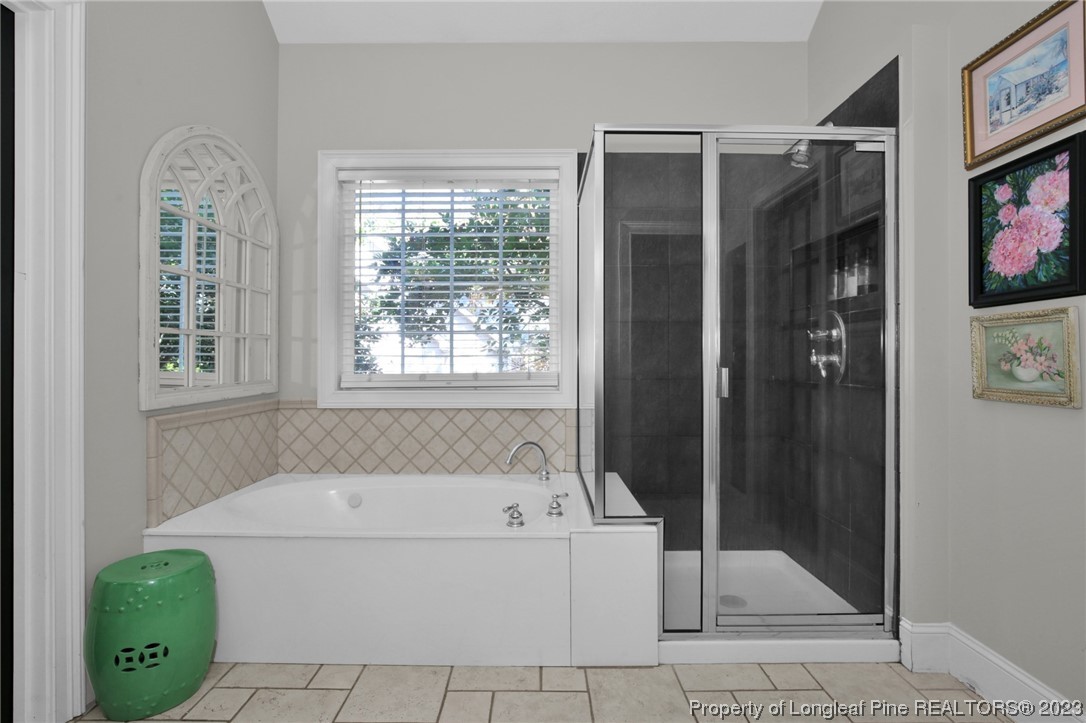 1145 Burning Tree Road Pinehurst, NC 28374 - Photo 23 of 45 a white bath tub sitting next to a shower