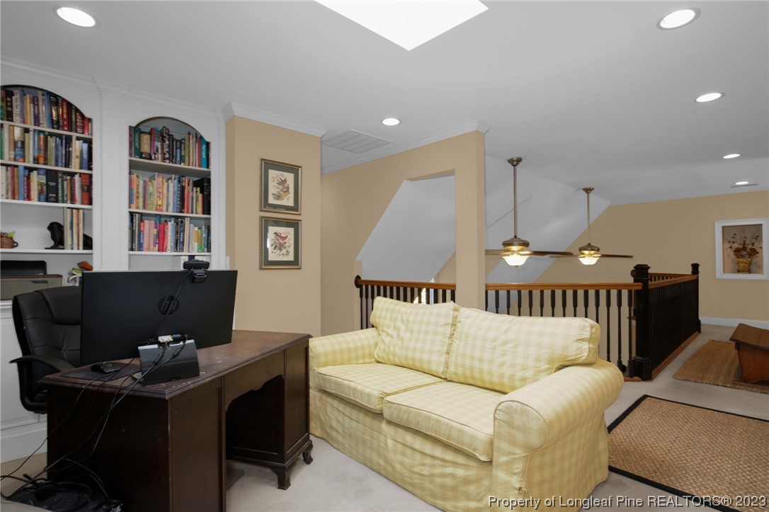 1145 Burning Tree Road Pinehurst, NC 28374 - Photo 25 of 45 a view of a livingroom with workspace and a couch