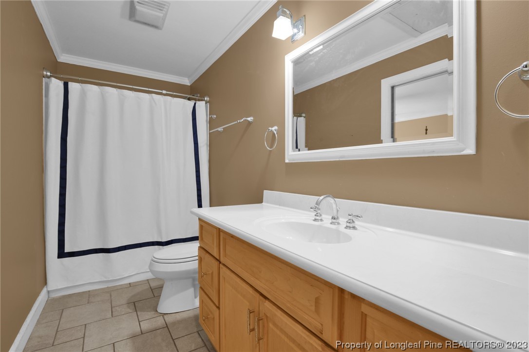 1145 Burning Tree Road Pinehurst, NC 28374 - Photo 28 of 45 a bathroom with a sink and a mirror