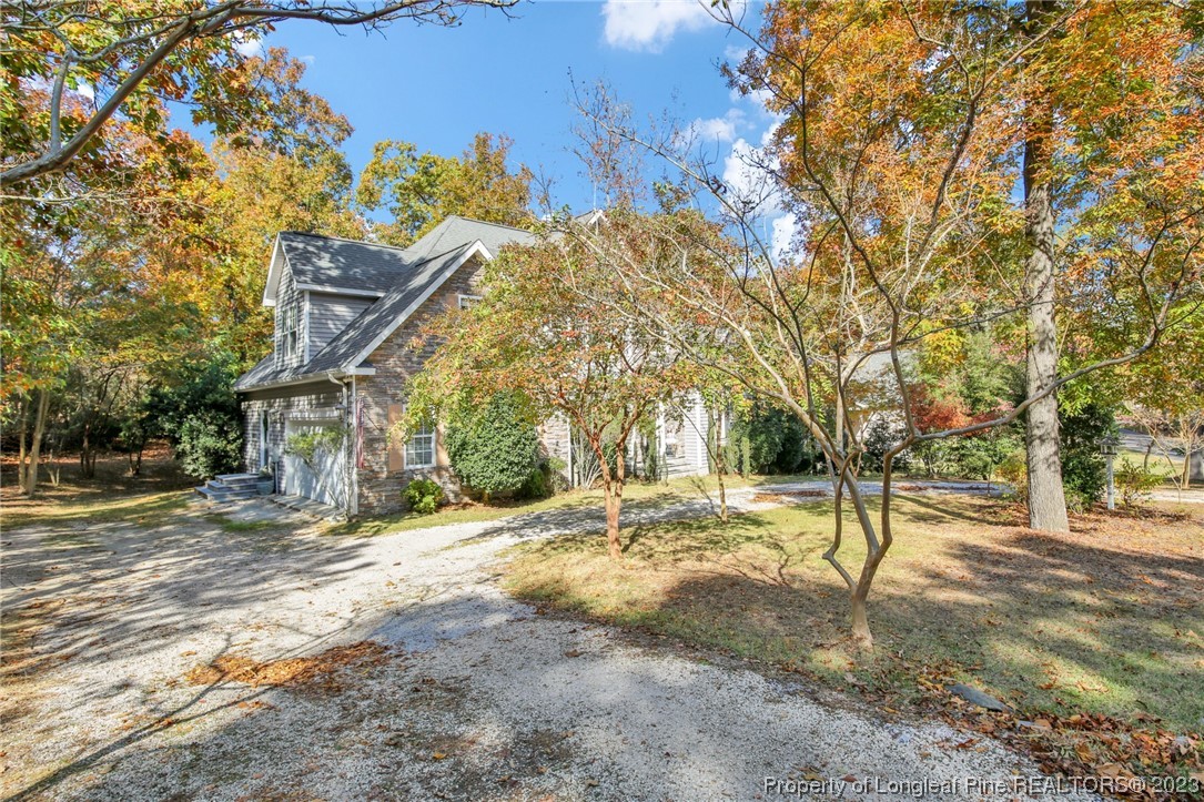 1145 Burning Tree Road Pinehurst, NC 28374 - Photo 43 of 45 a view of a yard with plants and trees