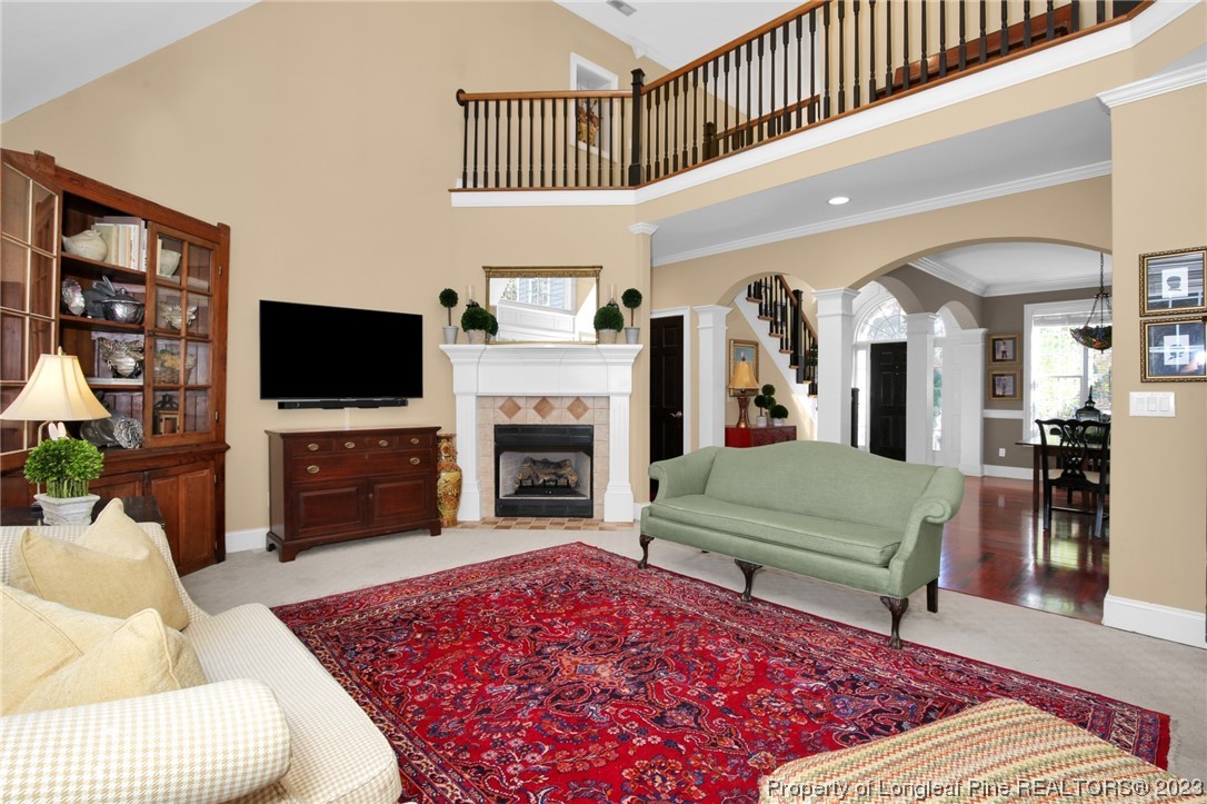 1145 Burning Tree Road Pinehurst, NC 28374 - Photo 9 of 45 a living room with furniture rug and a fireplace