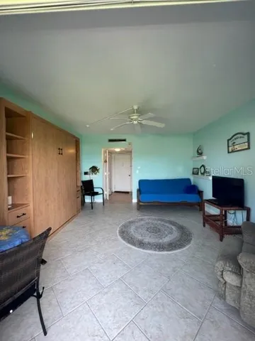 a living room with furniture a window and gym equipment