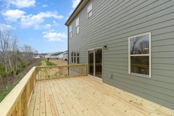 a view of a balcony with wooden floor and fence