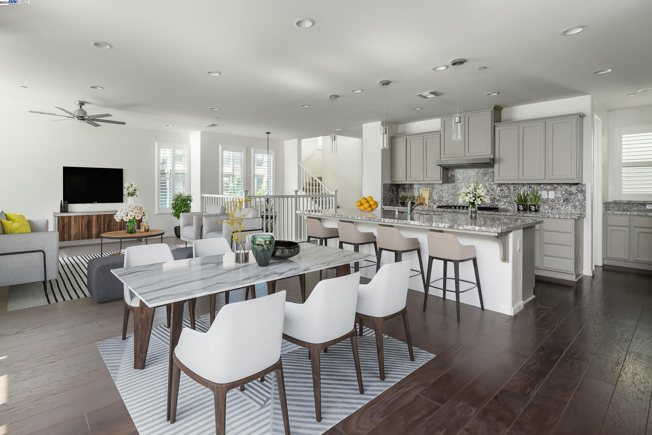 a kitchen with a dining table chairs and view living room