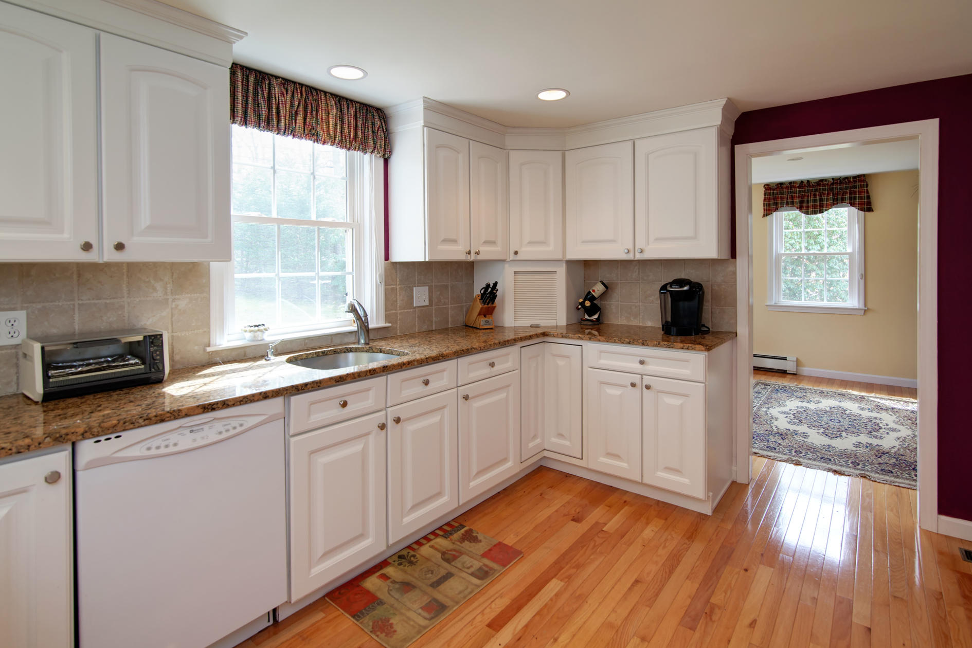 115 Holly Point Road Centerville, MA 02632 - Photo 18 of 26 a kitchen with wooden floors and white appliances
