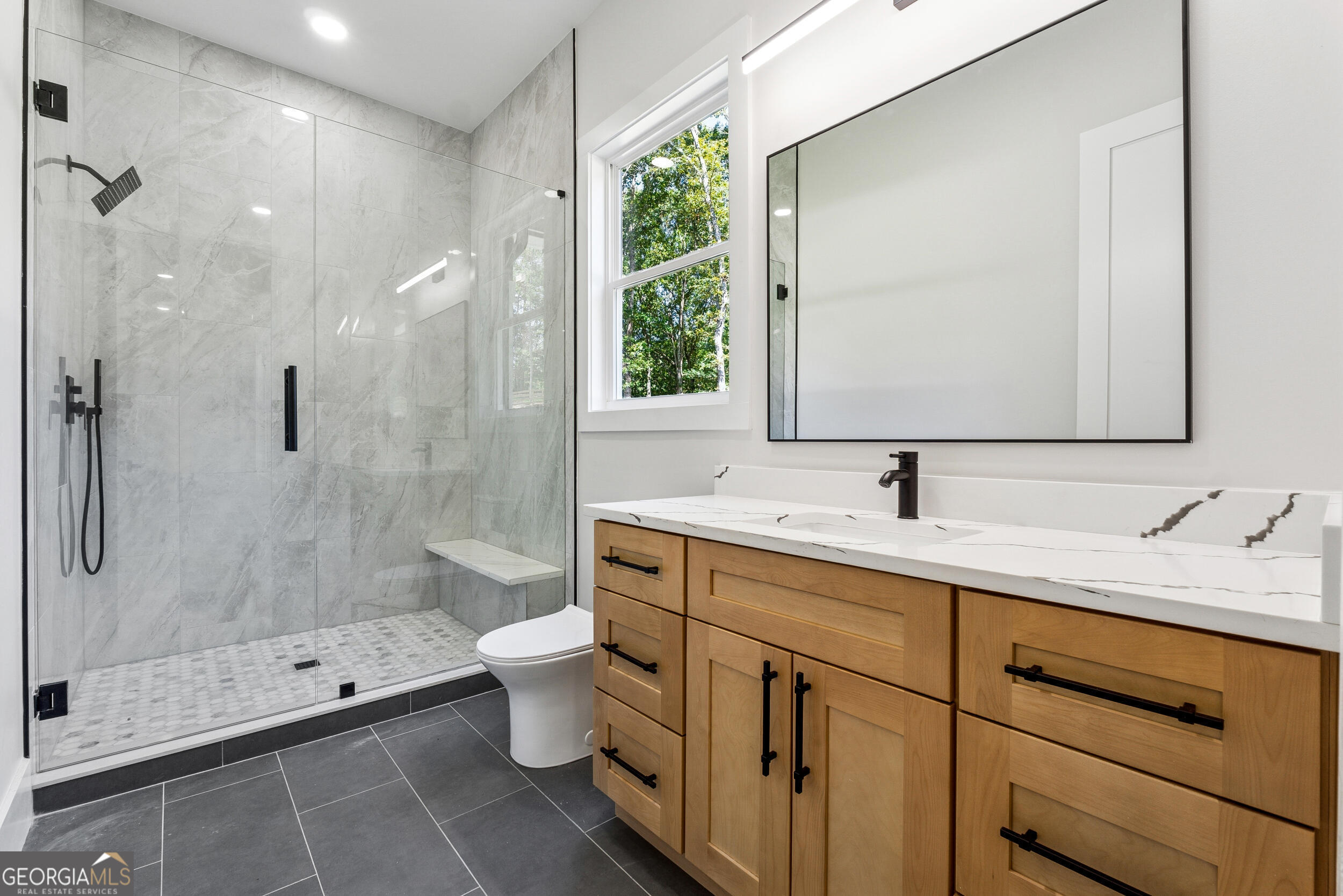 1622 Double Springs Monroe, GA 30656 - Photo 21 of 44 a bathroom with a double vanity sink toilet and shower