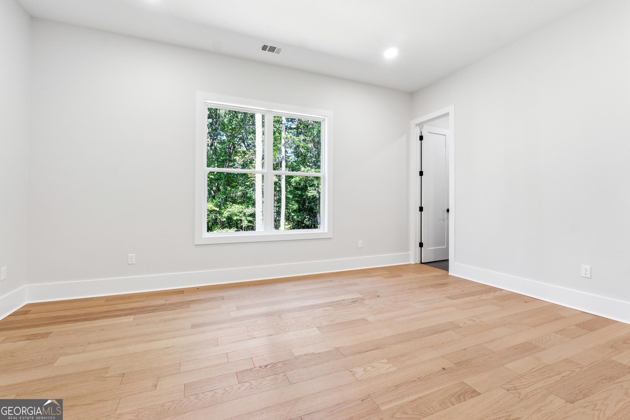 1622 Double Springs Monroe, GA 30656 - Photo 32 of 44 an empty room with wooden floor and windows