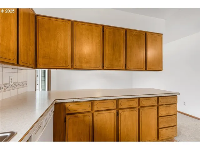 a kitchen with stainless steel appliances kitchen island granite countertop a stove a sink and a refrigerator