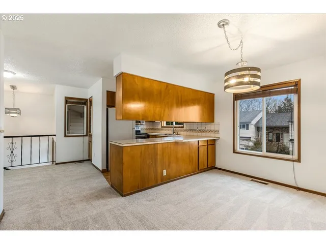 a kitchen with stainless steel appliances a stove top oven