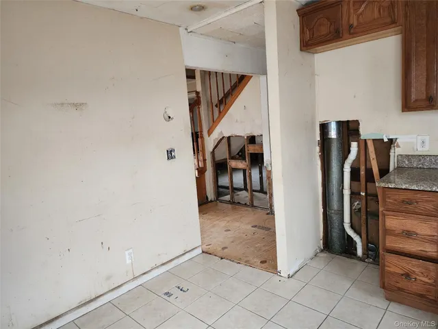 a view of a livingroom with furniture and staircase