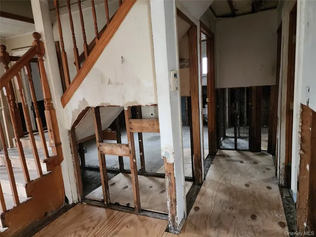 a view of an entryway with wooden floor and door
