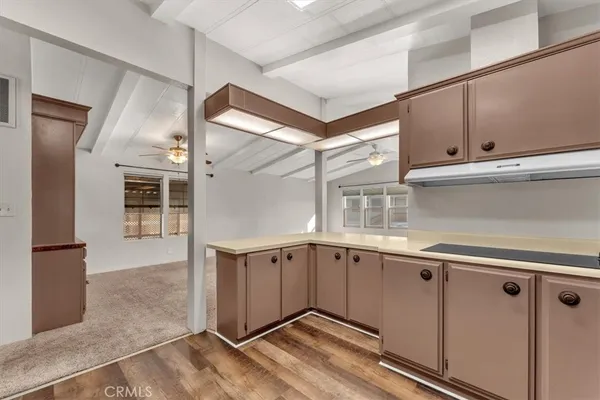 a kitchen with a sink a refrigerator and cabinets