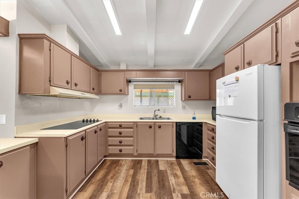 350 Gilmore Road, Unit 16 Red Bluff, CA 96080 - Photo 14 of 35 a kitchen with a sink a refrigerator and cabinets
