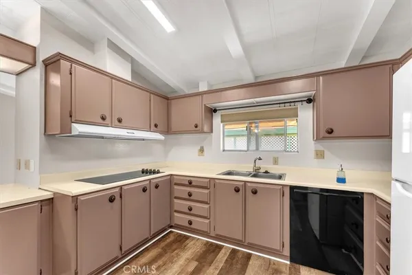 a kitchen with a refrigerator stove and sink