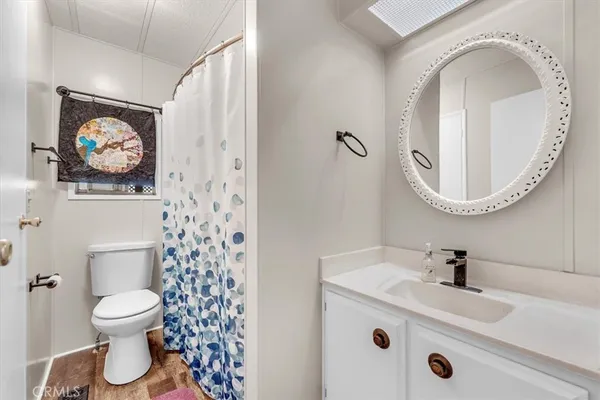 a kitchen with stainless steel appliances cabinets and wooden floor