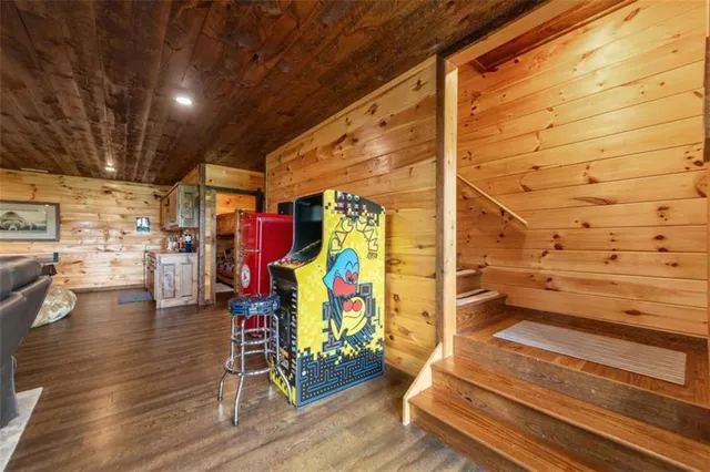 a spacious bedroom with a bed and wooden floor