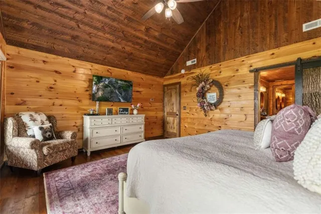 a bed room with a bed and a ceiling fan